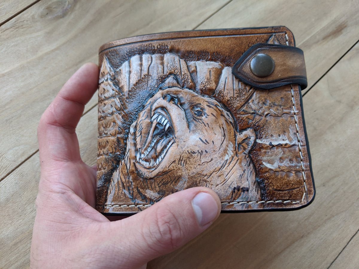 Handmade painted leather bifold wallet featuring a grizzly bear design, ideal for bikers and hunters