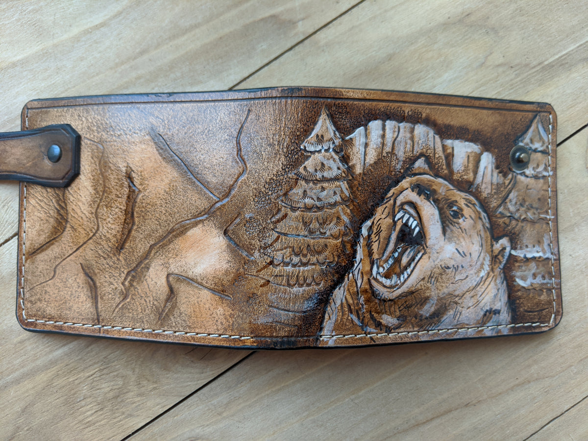 Handmade leather bifold wallet with carved grizzly bear design, perfect gift for bikers and hunters