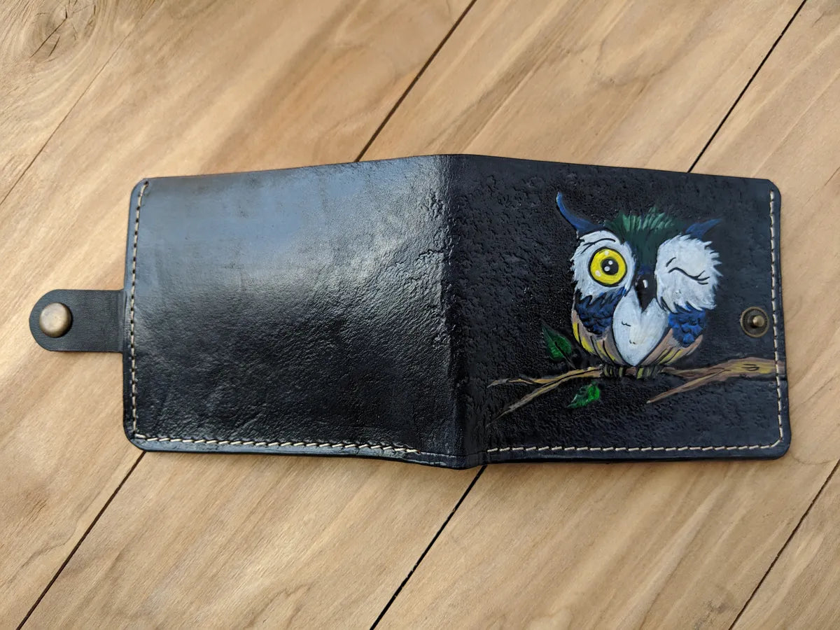 Holiday-themed owl design embossed on leather bifold wallet