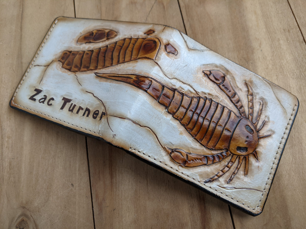 Handmade leather bifold wallet with carved Eurypterid sea scorpion fossil design, perfect gift for him