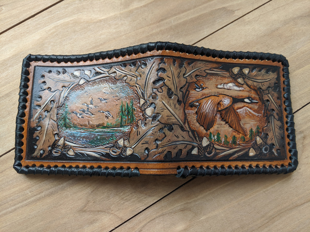 Handmade leather bifold wallet with painted goose hunting and oak leaf design, perfect Father's Day gift