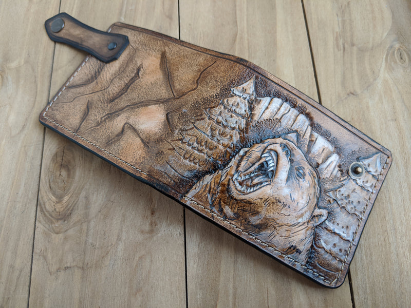Handmade embossed leather bifold wallet featuring a grizzly bear design, ideal for bikers and hunters