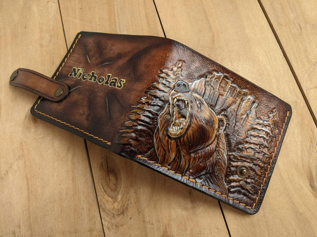 Handmade leather bifold wallet with carved grizzly bear design, ideal gift for outdoorsmen and bikers