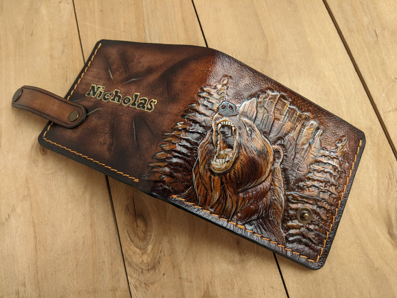 Handmade leather bifold wallet with carved grizzly bear design, ideal gift for outdoorsmen and bikers