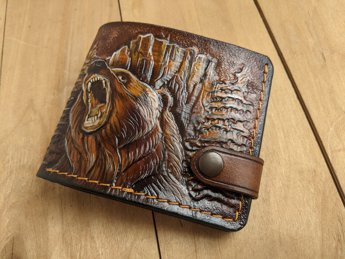 Handmade leather bifold wallet with tooled grizzly bear design, ideal gift for outdoorsmen and biker