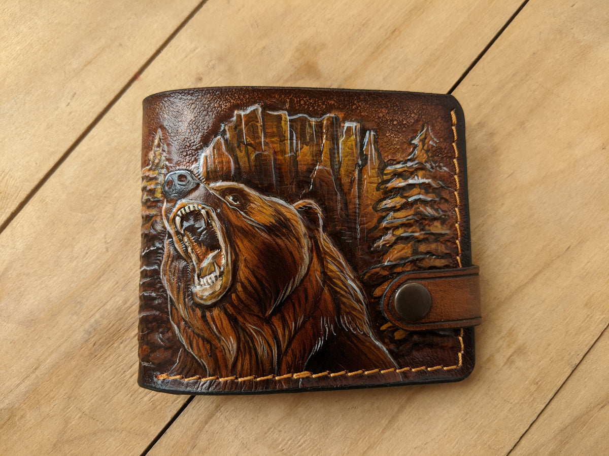 Handmade leather bifold wallet with painted grizzly bear design, ideal for outdoorsmen and bikers