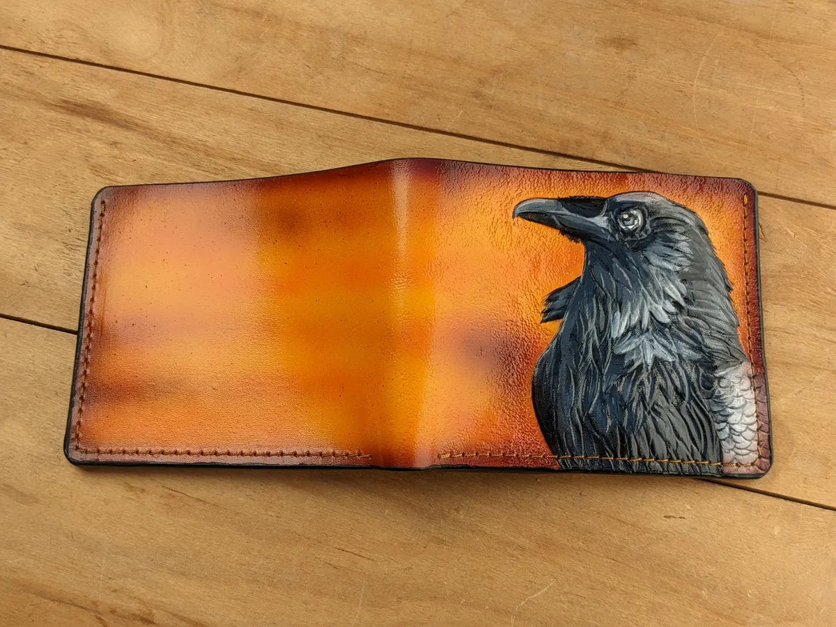Handmade bifold leather wallet with detailed raven embossing