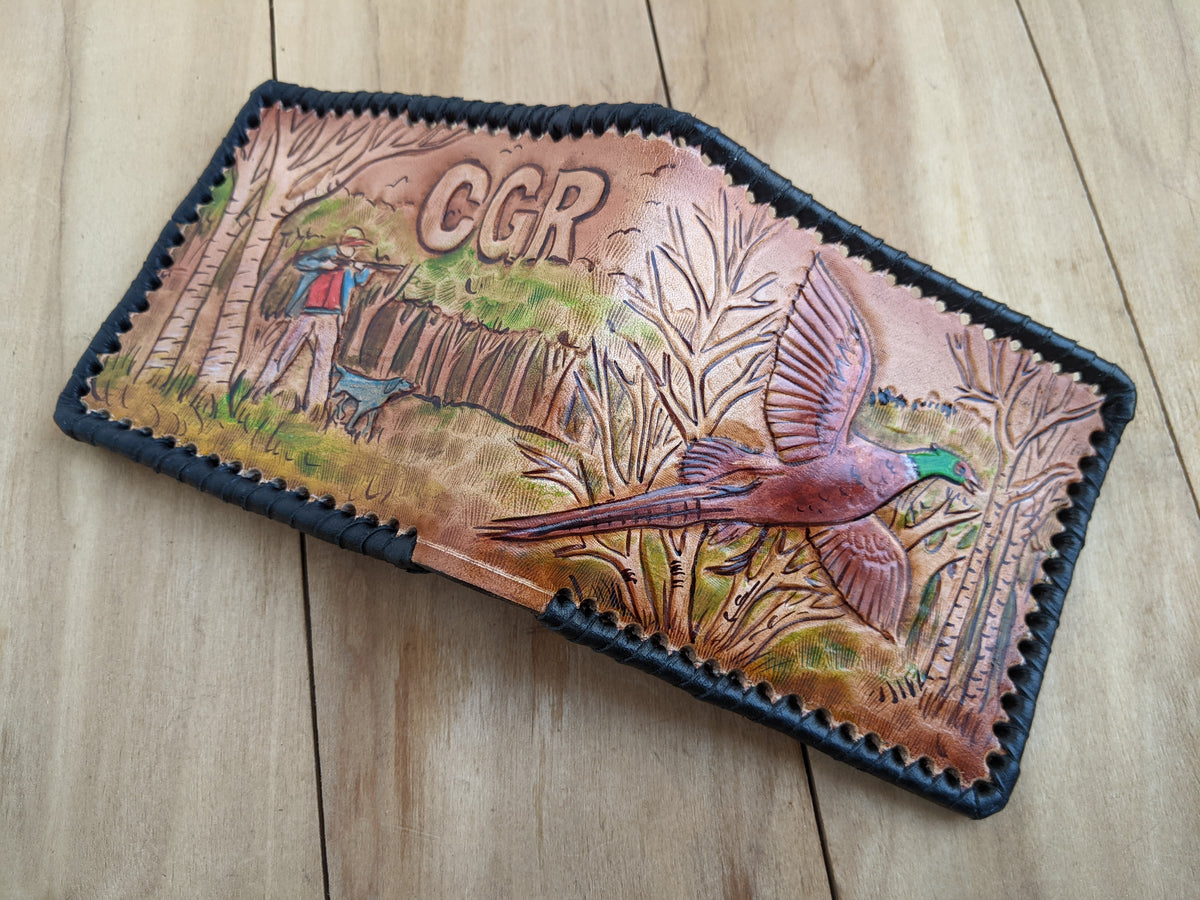 Shop the Hunter's Leather Wallet with pheasant hunting scene and rifle design. Handmade, RFID-protected, and perfect for outdoorsmen or as a Father's Day gift.