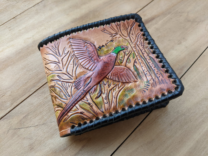 Shop the Hunter's Leather Wallet with pheasant hunting scene and rifle design. Handmade, RFID-protected, and perfect for outdoorsmen or as a Father's Day gift.
